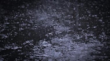 Heavy rain shower downpour cloudburst rainfall behind the glass.
