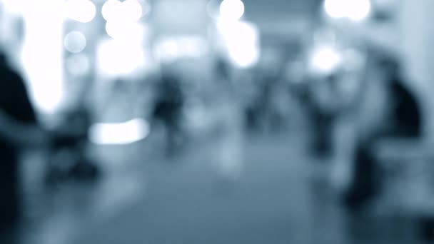 Many people walk inside the mall exhibition store. Blurred Background — Stock Video