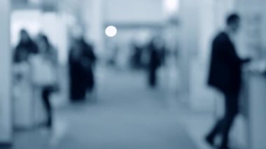 Bulanık arka plan çalışanları AVM 'de yürüyüş yapıyorlar.