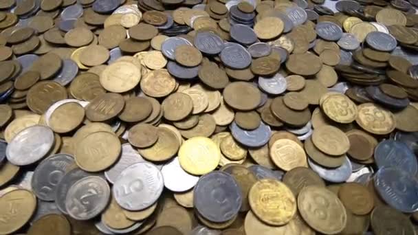 Weiße und gelbe Münzen fallen aus nächster Nähe auf die Oberfläche von Münzen. — Stockvideo