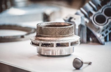 Metal 3D yazıcıya yazdırılmış nesneyi tutan adam