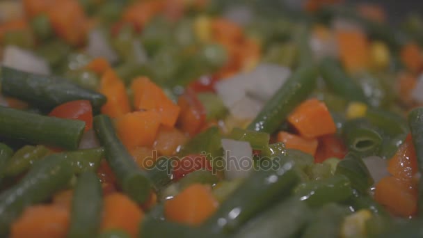 Vegetables cooking in a frying pan close up slow motion footage — Stock Video