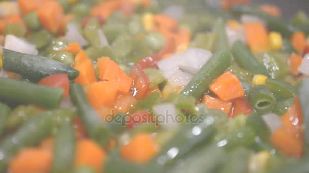 Vegetables cooking in a frying pan close up slow motion hd footage — Stock Video