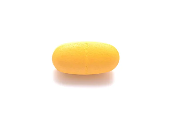 Une pilule jaune sur blanc, résumé médical — Photo