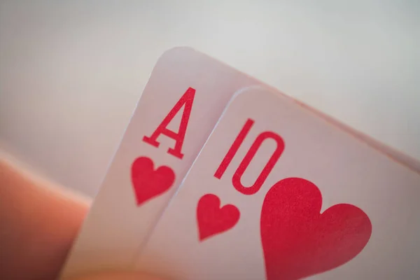 As de corazones y diez de corazones, Jugando cartas en la mano en la mesa, nands poker — Foto de Stock