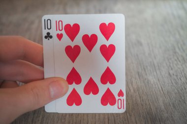 İki onlu, masada el ele kağıt oynuyor, poker oynuyorlar.