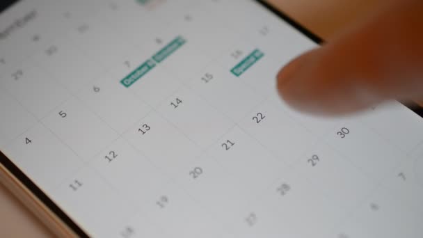 Man using calendar app on the mobile device closeup on white background — Stock Video