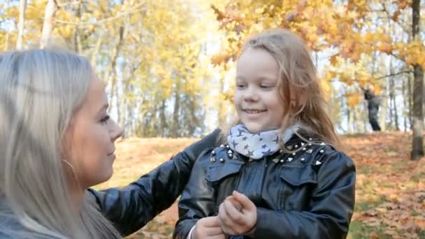 Материнская забота концепции, мама выпрямляет волосы для своей маленькой дочери — стоковое видео