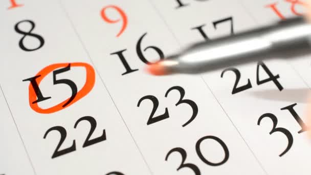Красный круг отмечен ручкой на листе календарных дат — стоковое видео