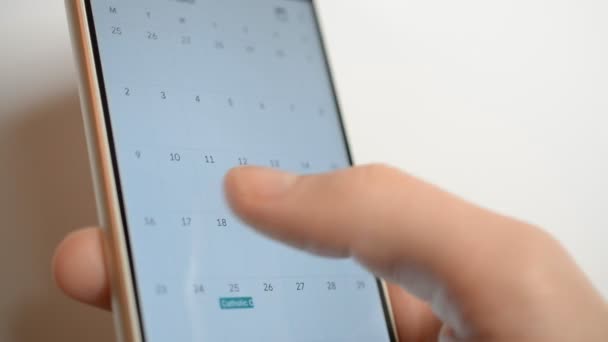 Man met behulp van kalender app op het mobiele apparaat closeup — Stockvideo
