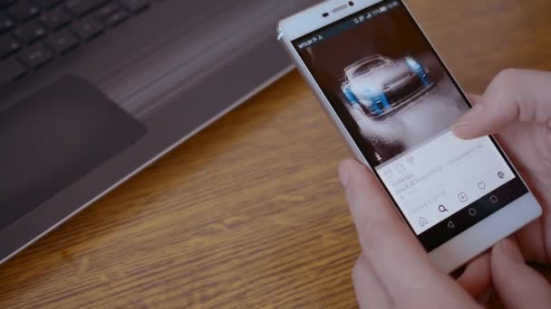 Gomel, Belarus - November 22, 2019: hands of a white man browsing a popular hashtag cars on Instagram. — ストック動画