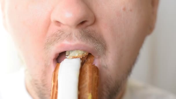 Closeup Mouth Young Man Eats Tasty Eclair Close — Stock Video