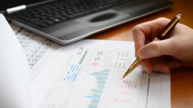 Businessman working and reads and writes markets trade reports, Business financial accounting concept.