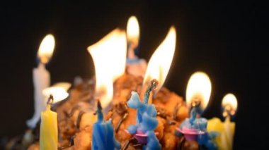 Candle flame burning light off on black background