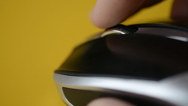 Close-up of a man hand uses white wireless mouse on yellow background — 비디오