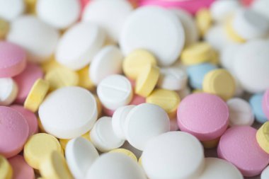 Background colored pink yellow and blue tablets