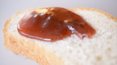 strawberry jam closeup drops on bread