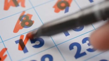 Calendar page, red marker crosses out the fifteenth and sixteenth number