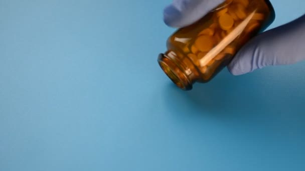 Bottle Of Pills Being Spilled Into A blue background — Stok video