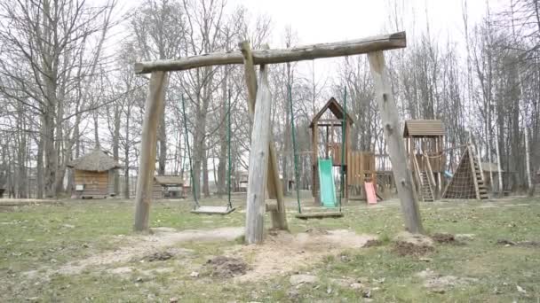 Empty childrens swing, coronovirus COVID-19 epidemic in europe and the world concept — Stock Video