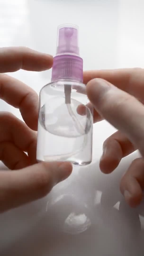 Man cleans hands with antiseptic bottle spraying — Stock Video