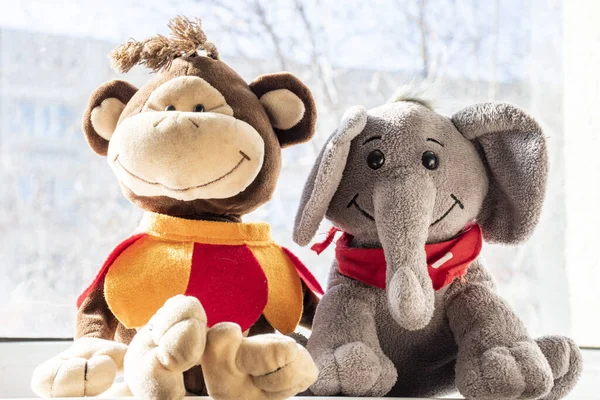 Stuffed toys elephant and monkey, friendship concept.