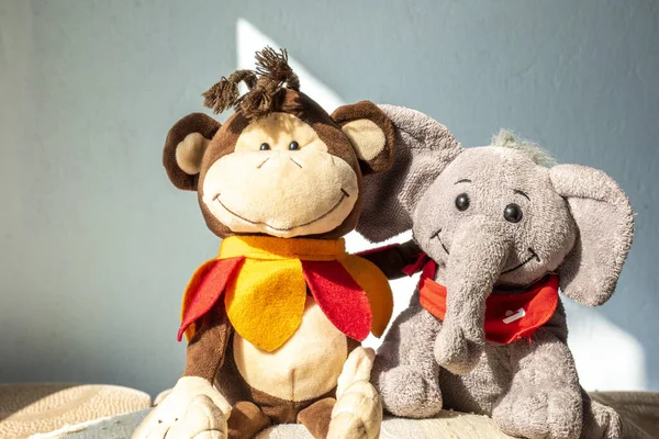 Stuffed toys elephant and monkey, friendship concept.