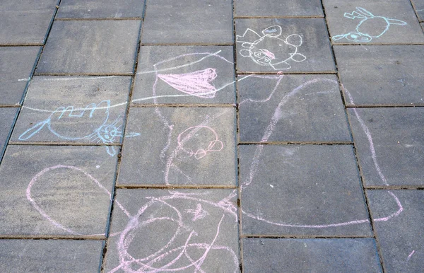 drawings of children with chalk on the sidewalk