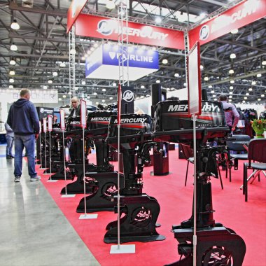 Moscow / Russia  03 05 2020:  Mercury new outboard motors on BRP Brunswick  exhibition stand on 13th International Moscow Boat Show 2020 at the Crocus Expo exhibition center clipart