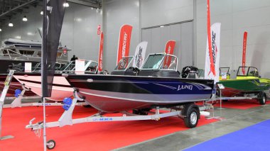 Moscow / Russia  03 05 2020: Utility aluminium riveted boat LUND 1675 Impact with Mercury outboard motor on 13th International Moscow Boat Show 2020 at the Crocus Expo exhibition center