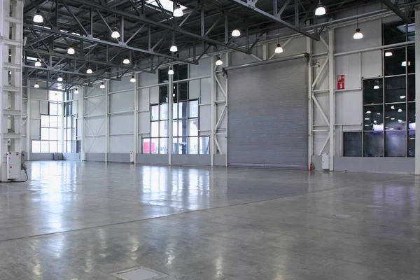 Empty modern storage warehouse  indoor interior with clear floor and big windows