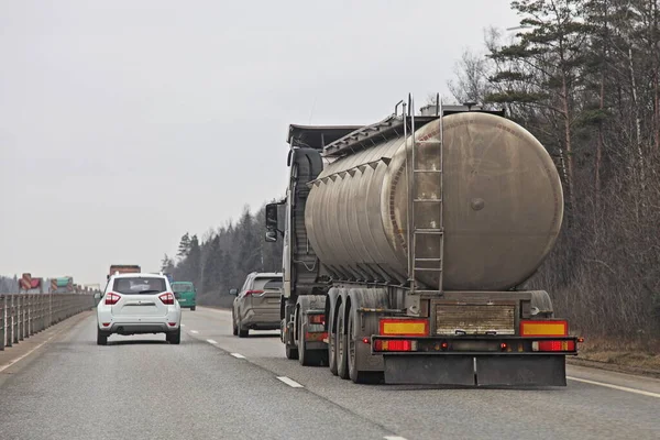 春天里 森林背景下的郊区双车道公路上的肮脏桶油罐车 液态货物运输 — 图库照片