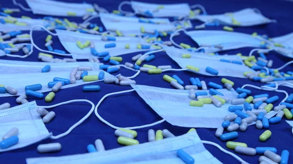 Many Medical Masks Pills Blue Backdrop Blurred Perspective Close Blue — Stock Photo, Image