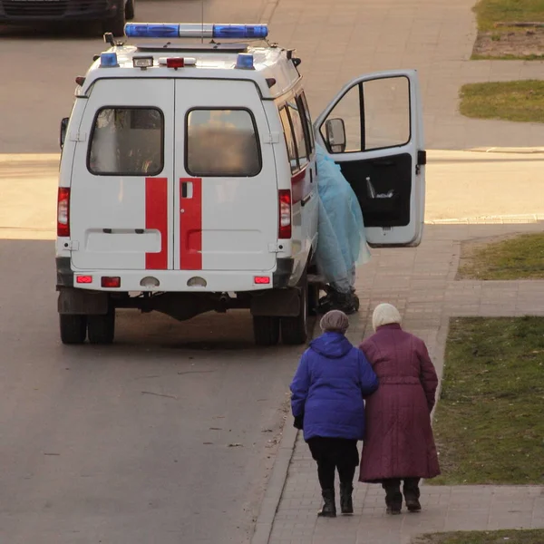 Two old women go to the doctor in an ambulance car, hospital walking