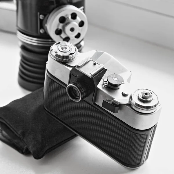 Retro SLR film camera body with top control panel wheels and viewfinder close up, retro photographer equipment