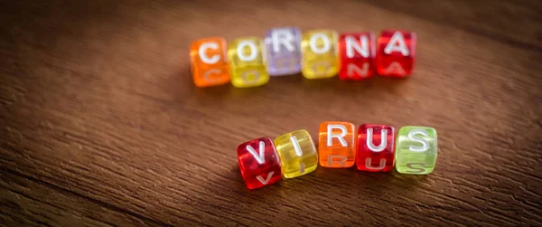 Colorful Corona Virus English Alphabet Cube Brown Color Background Selective — стоковое фото