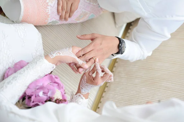 marriage hands with rings. birde wears the ring on the finger of the groom
