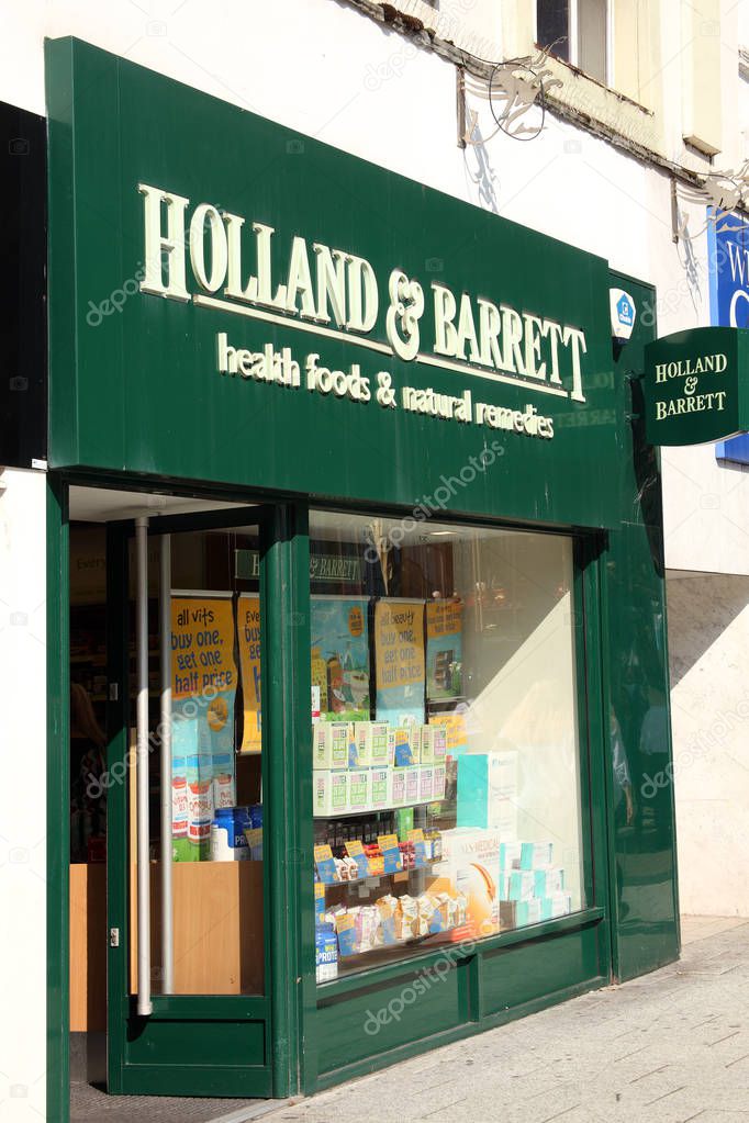 Cardiff, Wales, UK, September 14, 2016 :  Holland & Barrett logo advertising sign outside its retail  store in Queen Street
