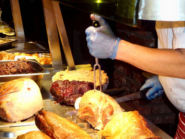 Chef carving roast meat