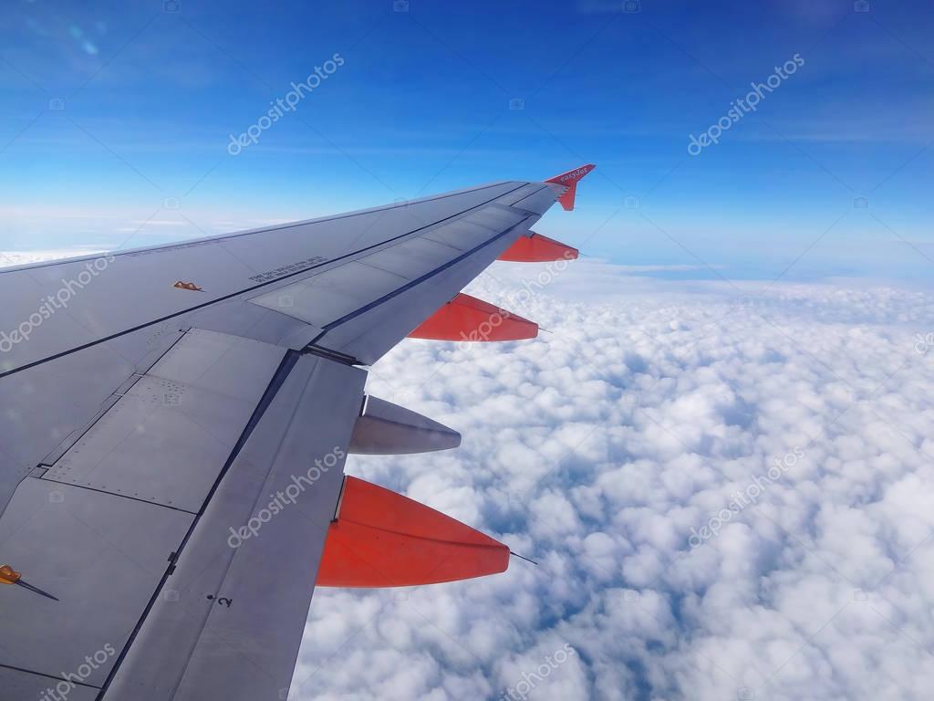 London, UK, March 15, 2014 : EasyJet jet aeroplane flying above the clouds in mid air on it's way to a holiday destination
