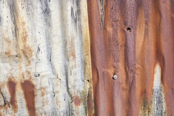Distressed old corrugated rust covered iron fence background