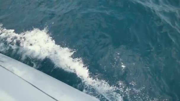 Яхта ломает волны замедленного движения, стреляя в чистую голубую воду — стоковое видео