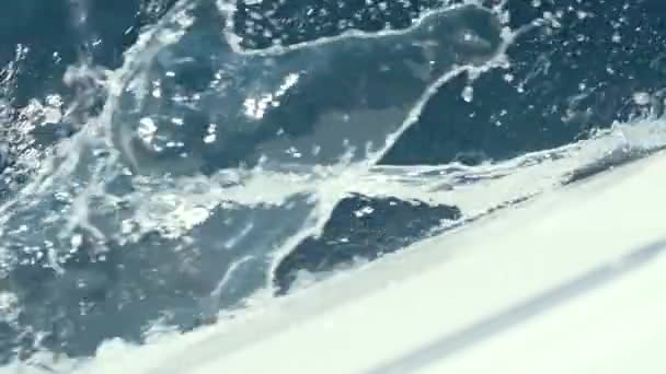 Yacht breaks the waves slow motion shot clear blue water — Stock Video