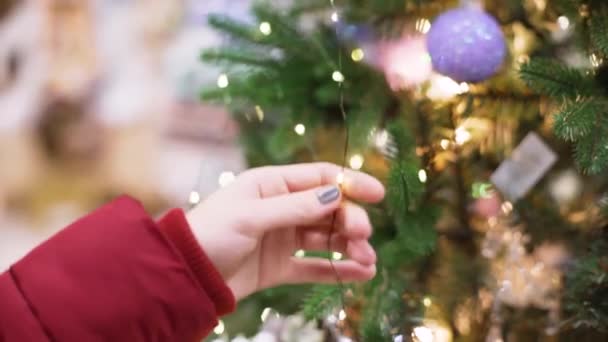 Крупным планом женщина на рынке выбирает рождественские украшения — стоковое видео