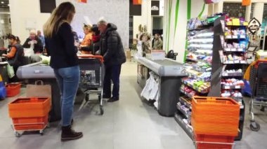 LVIV, UKRAINE - DECEMBER 29, 2019: Unknown people pay for cash purchases. Shooting in mall.