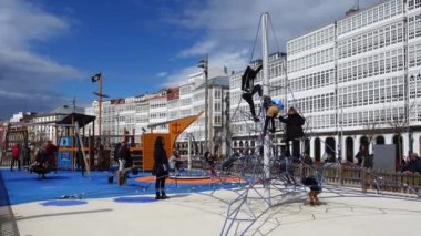 LA CORUNA, SPAIN - APRIL 2, 2018: Children at the playground on the city embankment. La Coruna the large city in the northwest of Spain, the resort and the port.