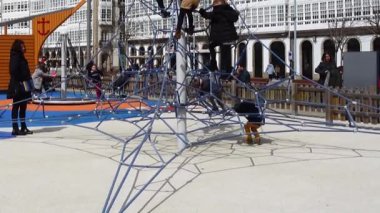 LA CORUNA, SPAIN - APRIL 2, 2018: Children at the playground on the city embankment. La Coruna the large city in the northwest of Spain, the resort and the port.