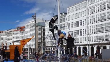 LA CORUNA, SPAIN - APRIL 2, 2018: Children at the playground on the city embankment. La Coruna the large city in the northwest of Spain, the resort and the port.