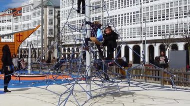 LA CORUNA, SPAIN - APRIL 2, 2018: Children at the playground on the city embankment. La Coruna the large city in the northwest of Spain, the resort and the port.