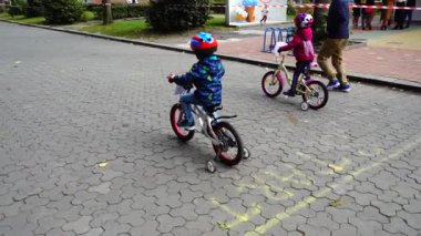 LVIV, UKRAINE - SEPTEMBER 21, 2019: Children 's cycling in the city park. Slow motion.